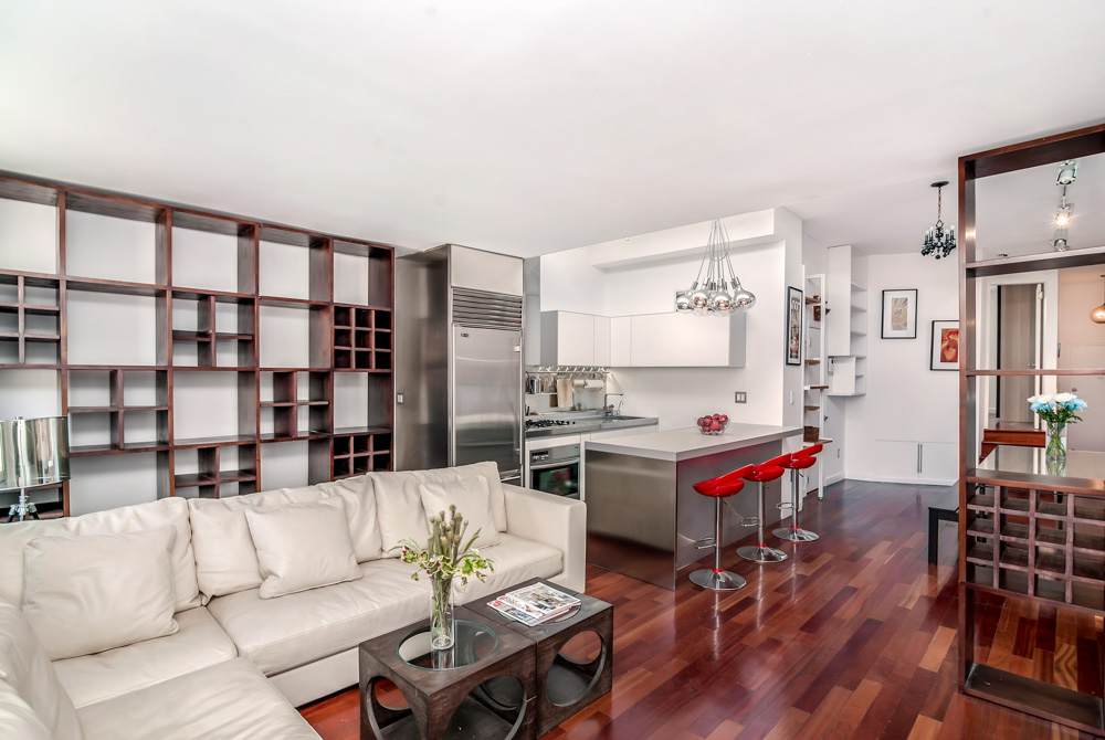 14 Prince Street, Unit 6C Manhattan, NY 10012 - Photo 4 of 9 a living room with furniture kitchen view and a large window