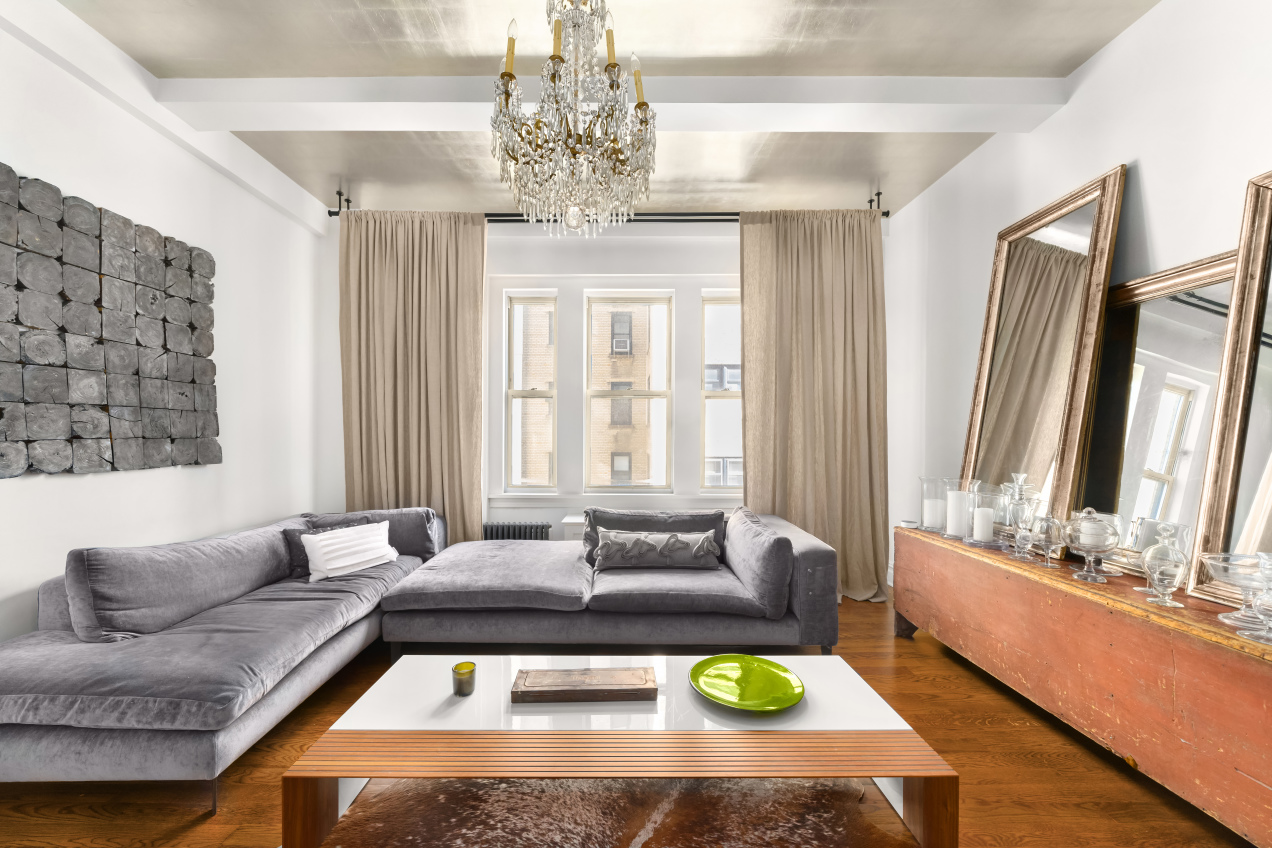 a living room with furniture and a chandelier