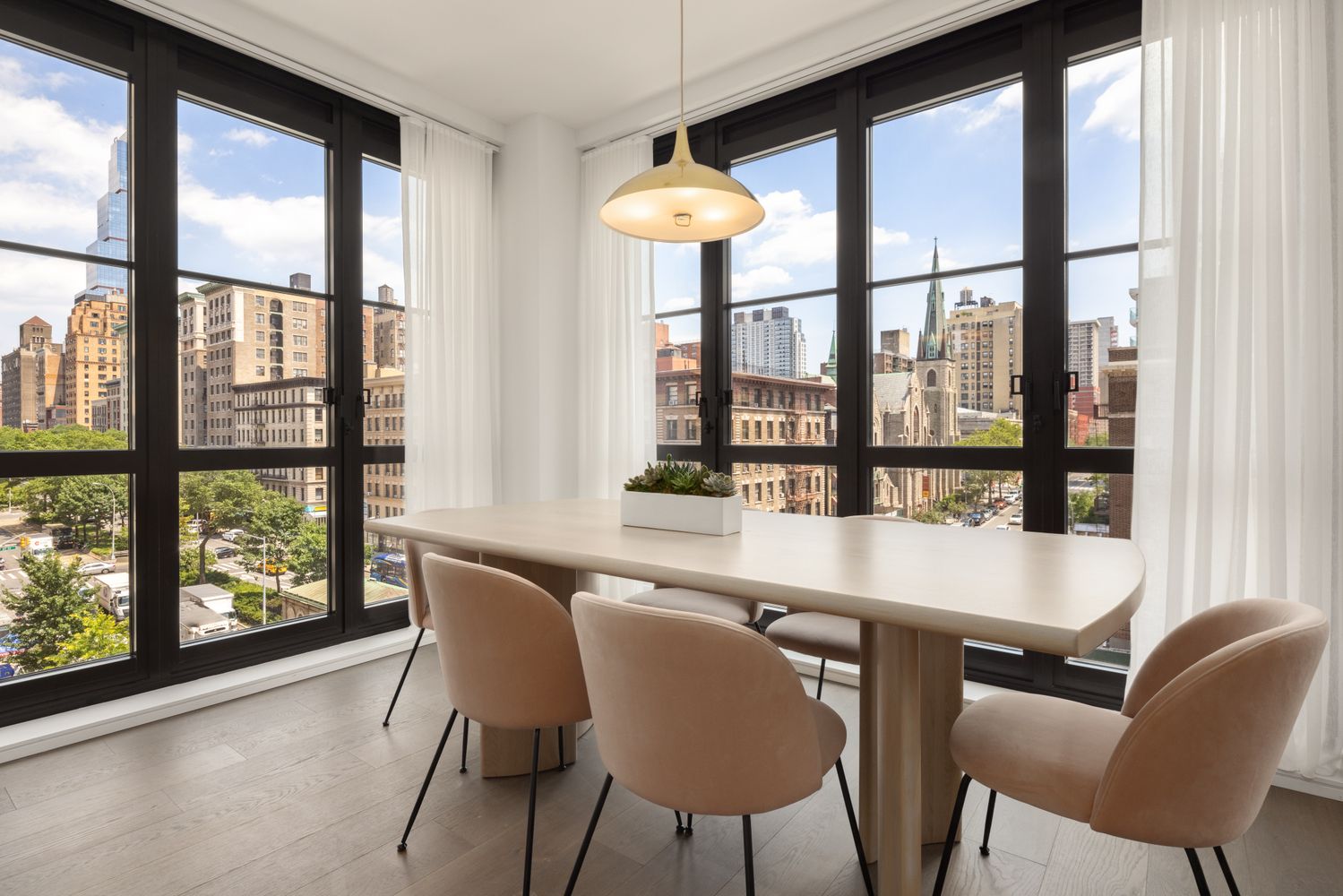 a view of a dining room with furniture and large windows