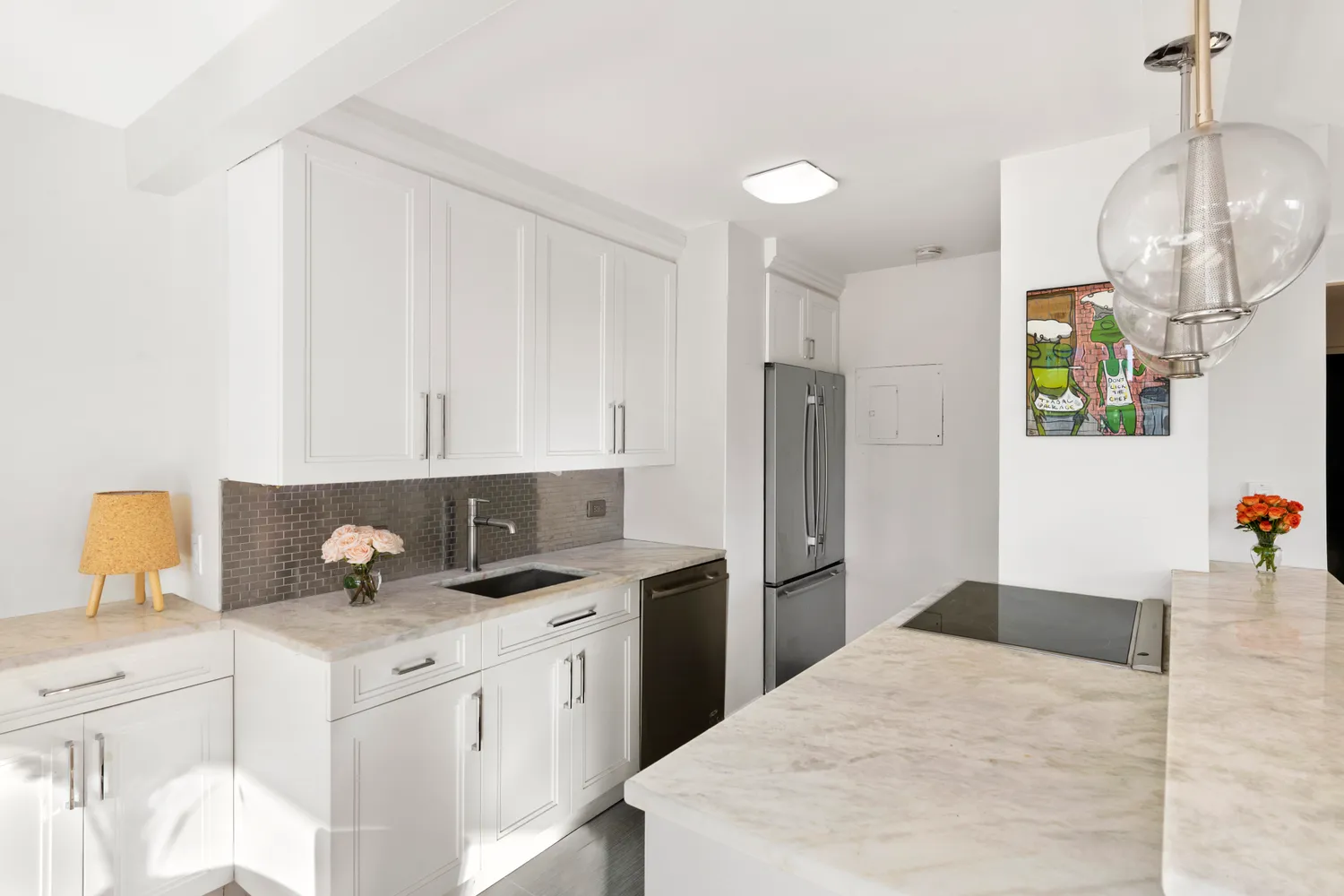 a kitchen with a sink dishwasher and a refrigerator
