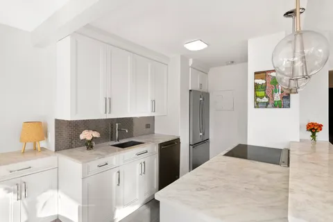 a kitchen with a sink dishwasher and a refrigerator