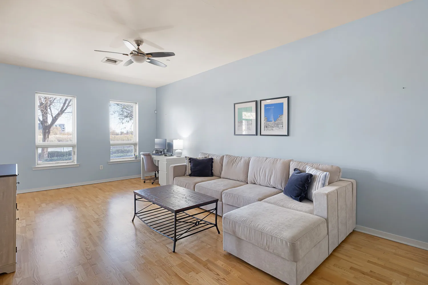 a living room with furniture and a wooden floor