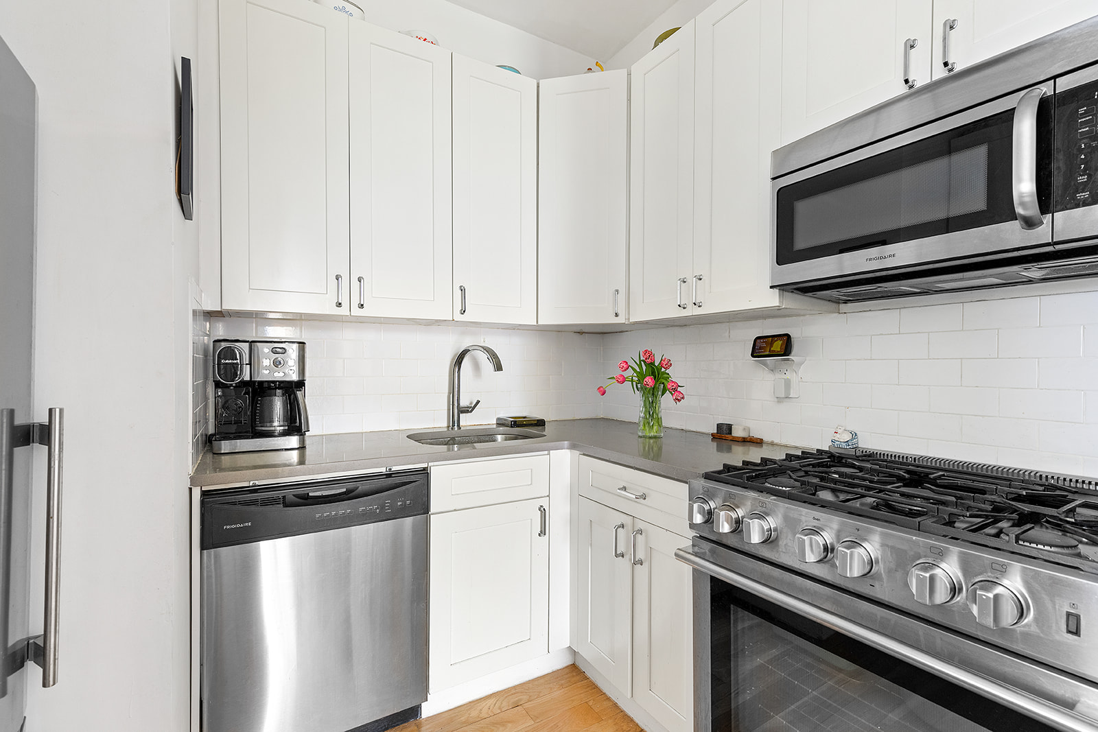 1474 Bushwick Avenue, Unit 4R Brooklyn, NY 11207 - Photo 2 of 8 a kitchen with stainless steel appliances granite countertop a stove a microwave and cabinets
