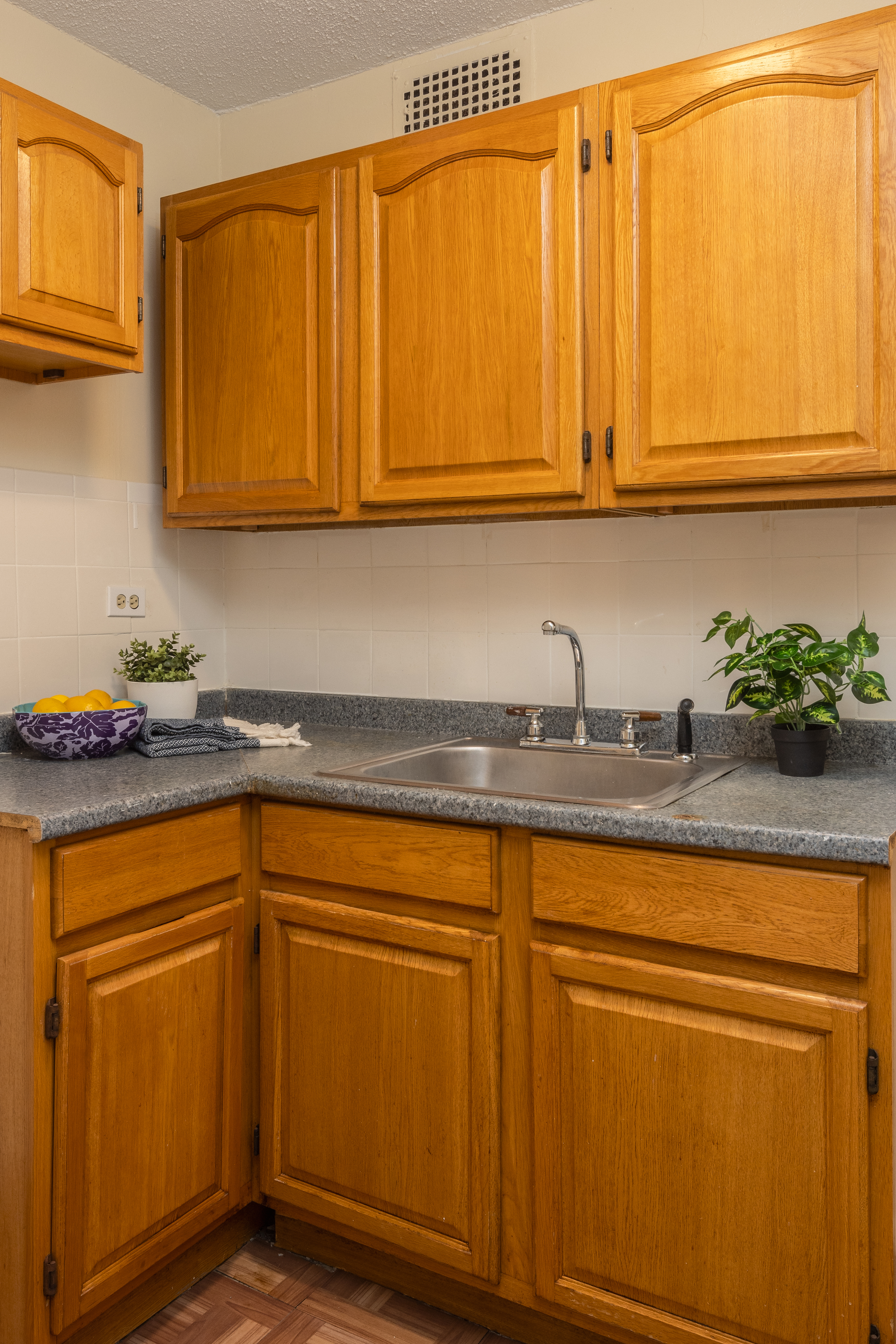 195 Willoughby Avenue, Unit 1610 Brooklyn, NY 11205 - Photo 4 of 7 a kitchen with stainless steel appliances granite countertop white cabinets sink and a granite counter top