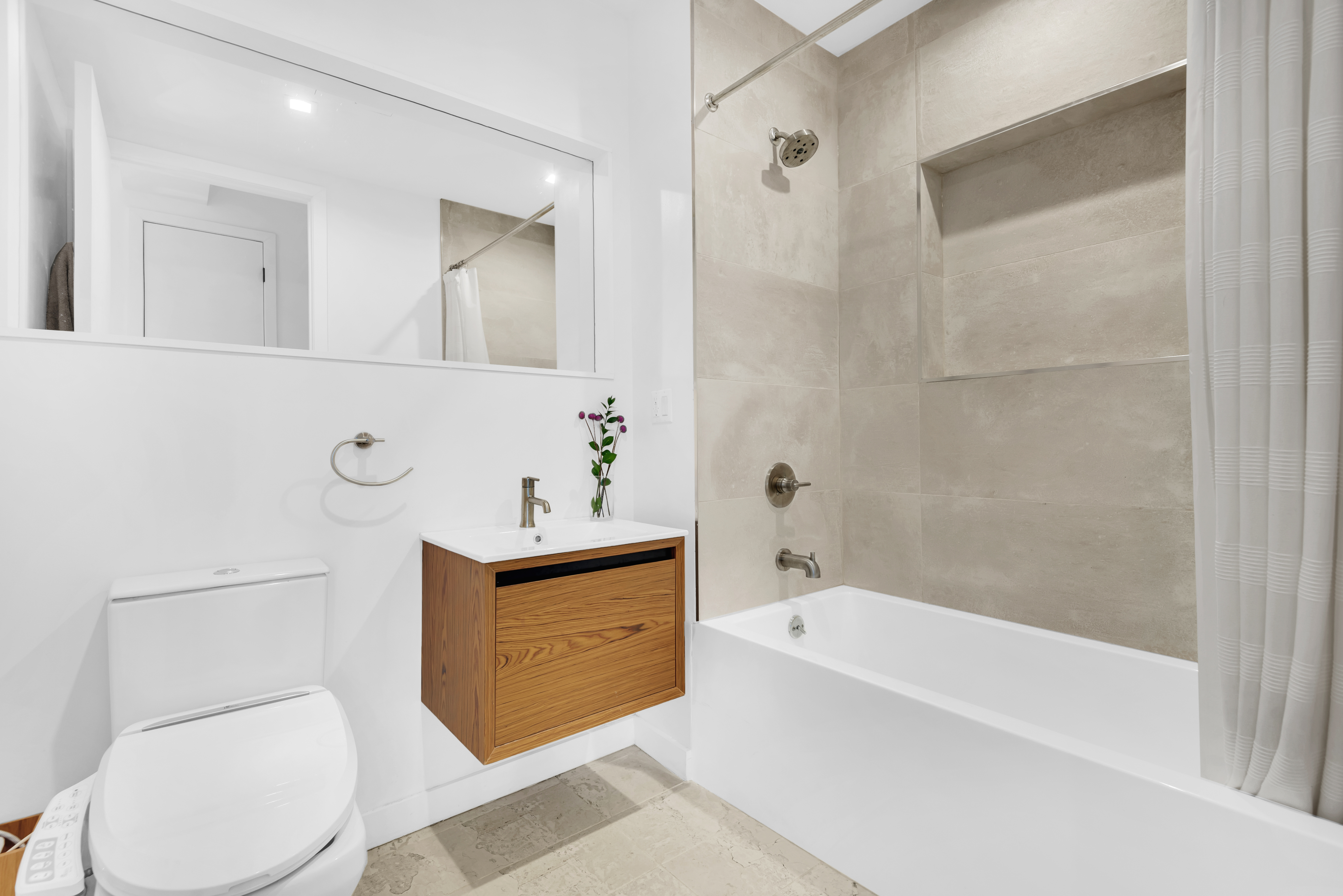 267 Evergreen Avenue, Unit 3A Brooklyn, NY 11221 - Photo 9 of 16 a bathroom with a sink a toilet and shower