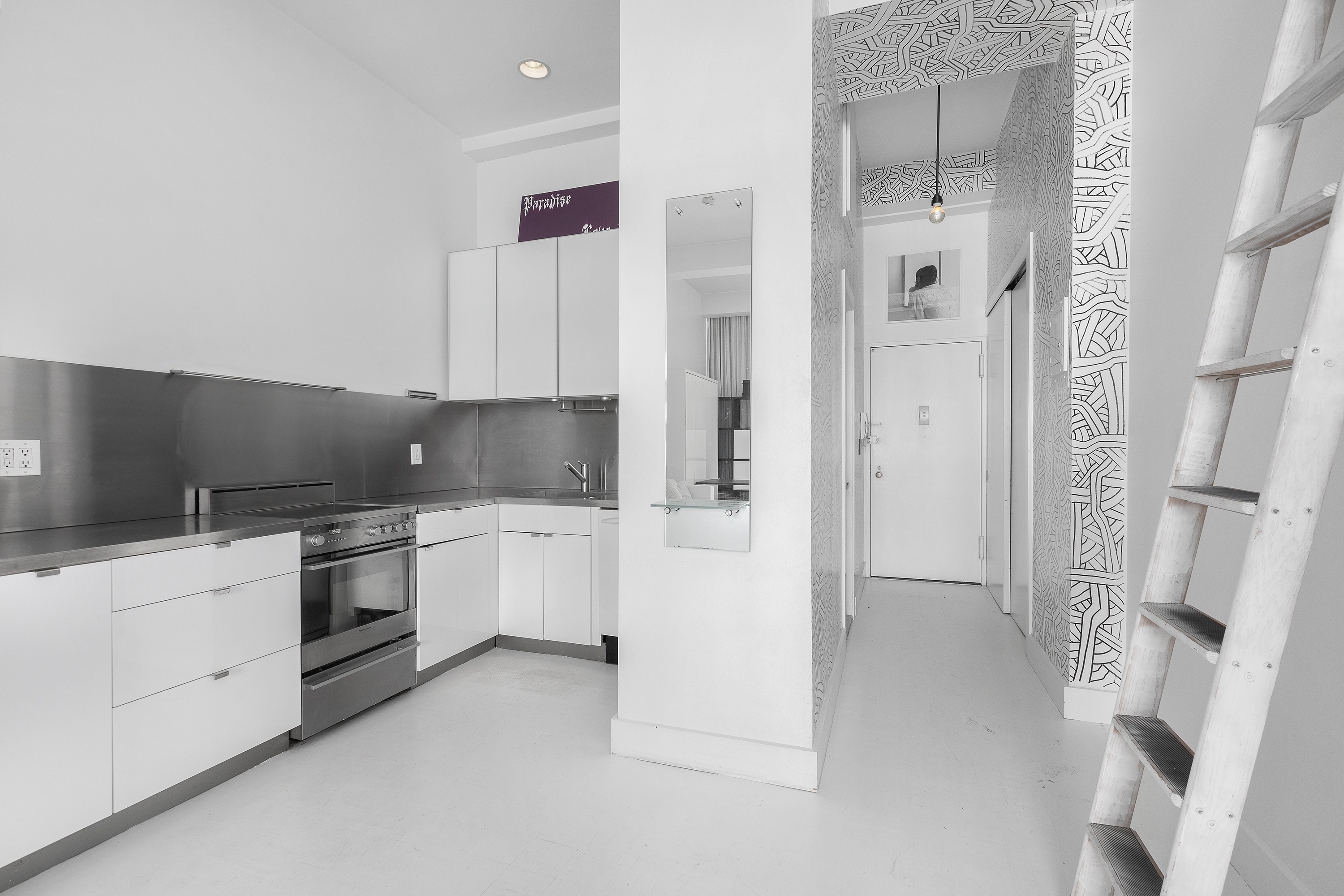 244 Madison Avenue, Unit PHE Manhattan, NY 10016 - Photo 8 of 20 a kitchen with stainless steel appliances white cabinets and white appliances
