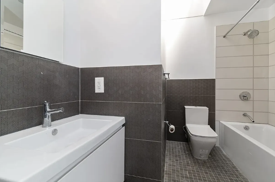 278 Macon Street, Unit 1 Brooklyn, NY 11216 - Photo 5 of 7 a bathroom with a sink toilet and shower