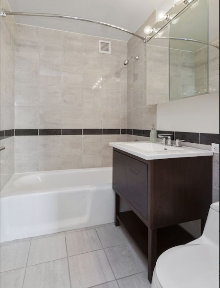 35 West 33rd Street, Unit 16F Manhattan, NY 10001 - Photo 11 of 34 a bathroom with a sink and a bathtub