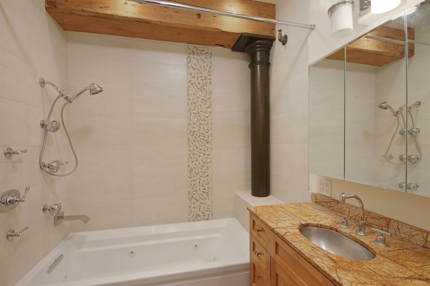 108 Wooster Street, Unit 4C Manhattan, NY 10012 - Photo 6 of 9 a bathroom with a granite countertop sink a mirror and a shower