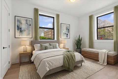 a bedroom with a bed and a painting on the wall