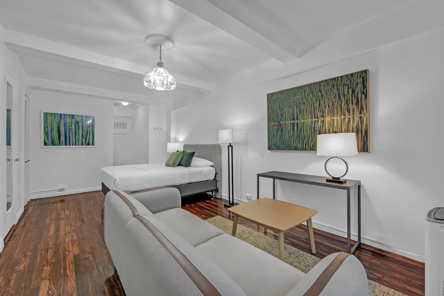 a living room with furniture and a wooden floor