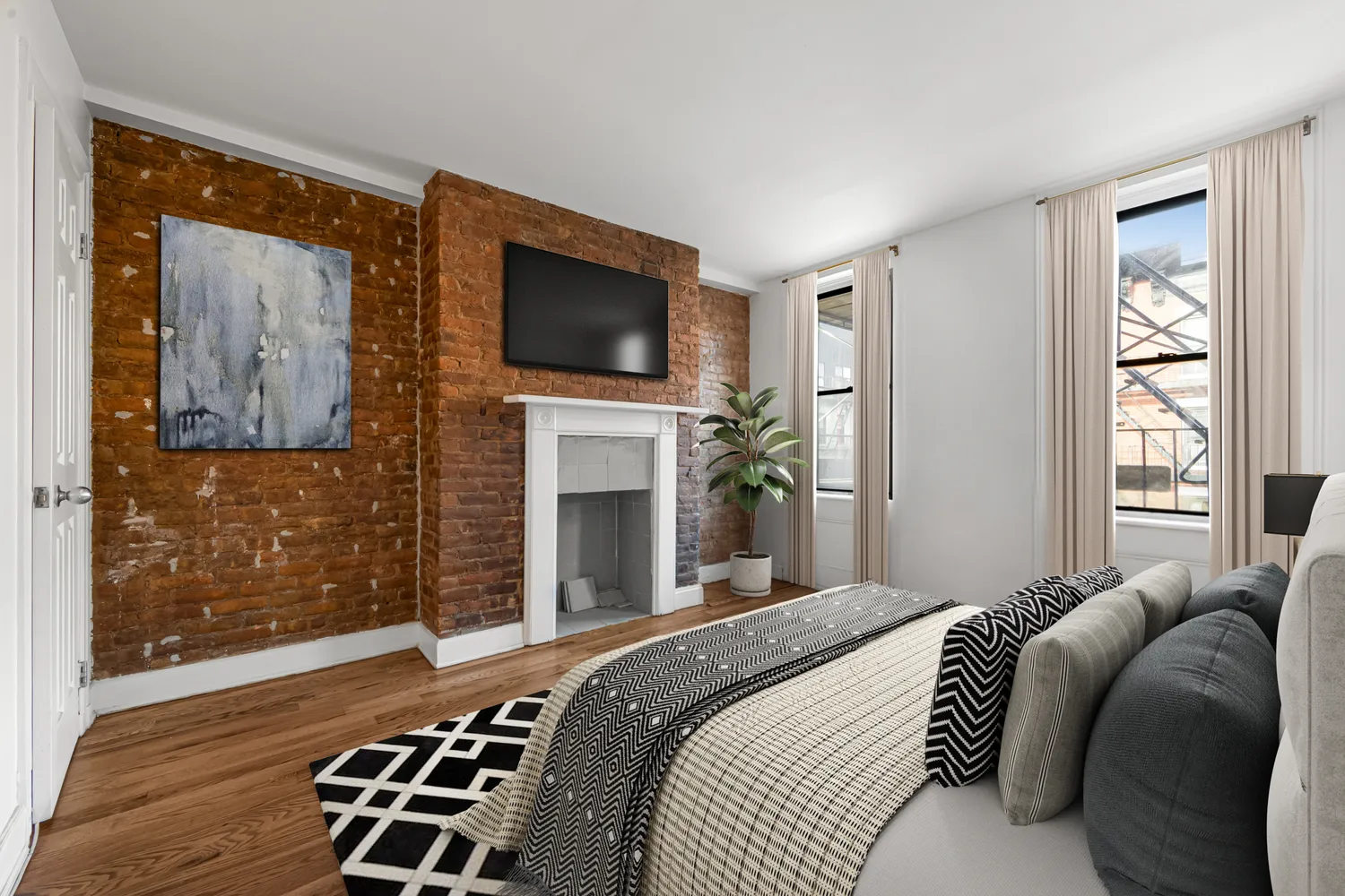 a bedroom with a bed and a television