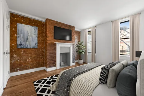 a bedroom with a bed and a television