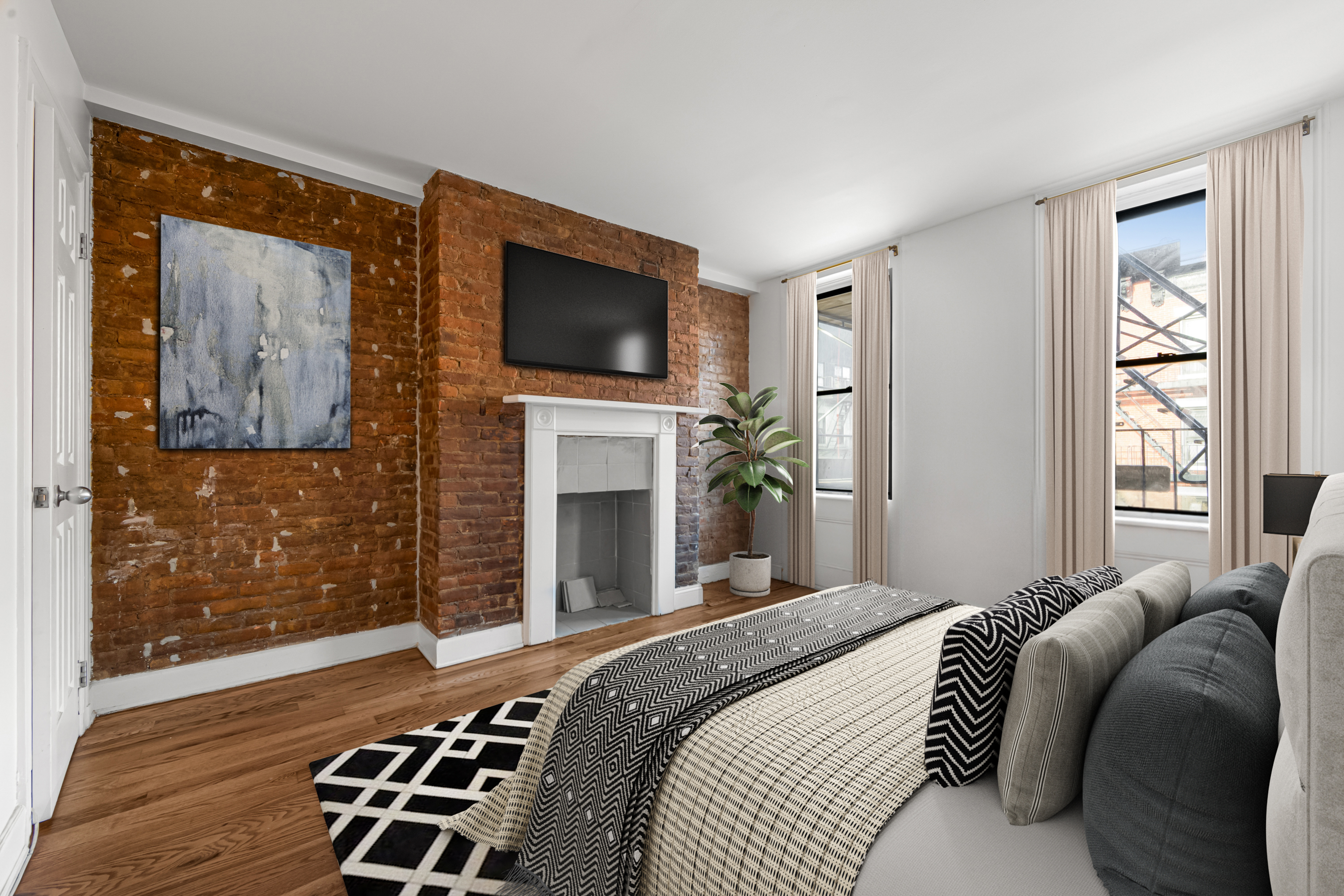 504 East 6th Street, Unit 6 Manhattan, NY 10009 - Photo 3 of 19 a bedroom with a bed and a television