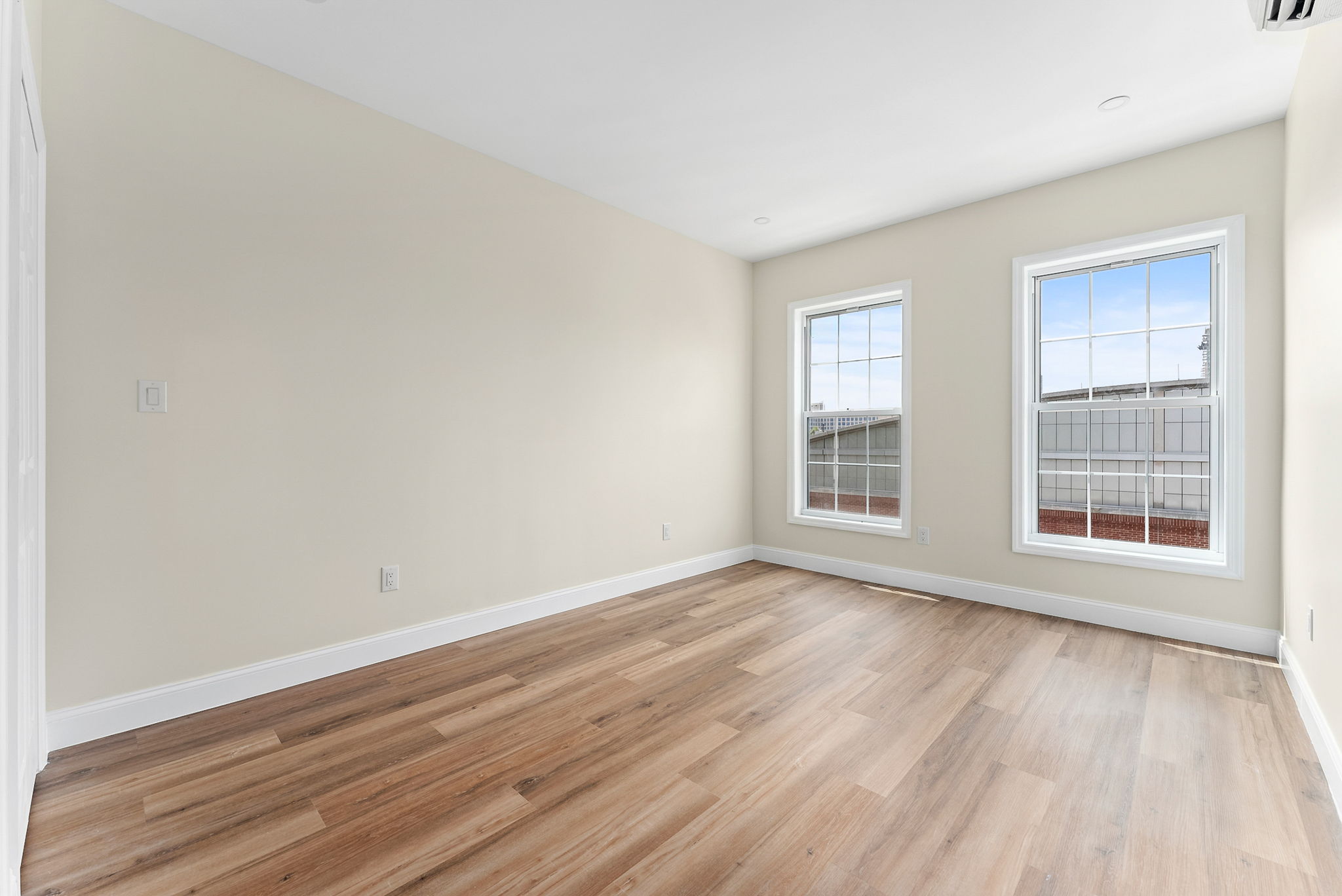 217 Butler Street, Unit 2 Brooklyn, NY 11217 - Photo 9 of 15 a view of an empty room with wooden floor and a window