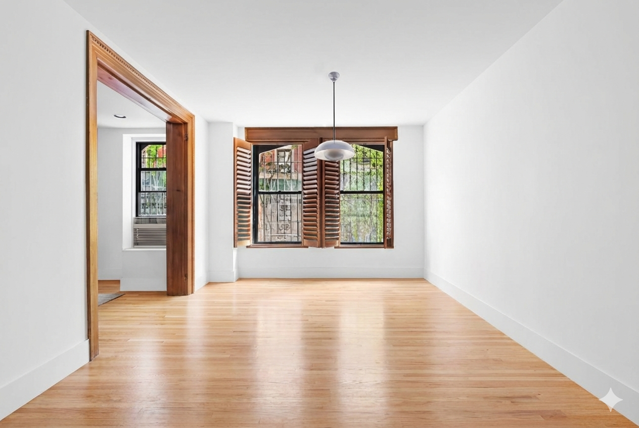 311 West 97th Street, Unit 1W Manhattan, NY 10025 - Photo 10 of 15 a view of an empty room with wooden floor and a window