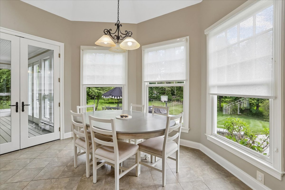 11736 Gainsborough Road Potomac, MD 20854 - Photo 42 of 90 a dining room with furniture large windows and a chandelier