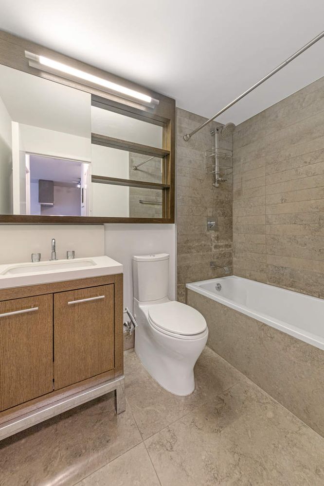 225 Rector Place, Unit 7M Manhattan, NY 10280 - Photo 6 of 13 a bathroom with a sink a toilet and bathtub