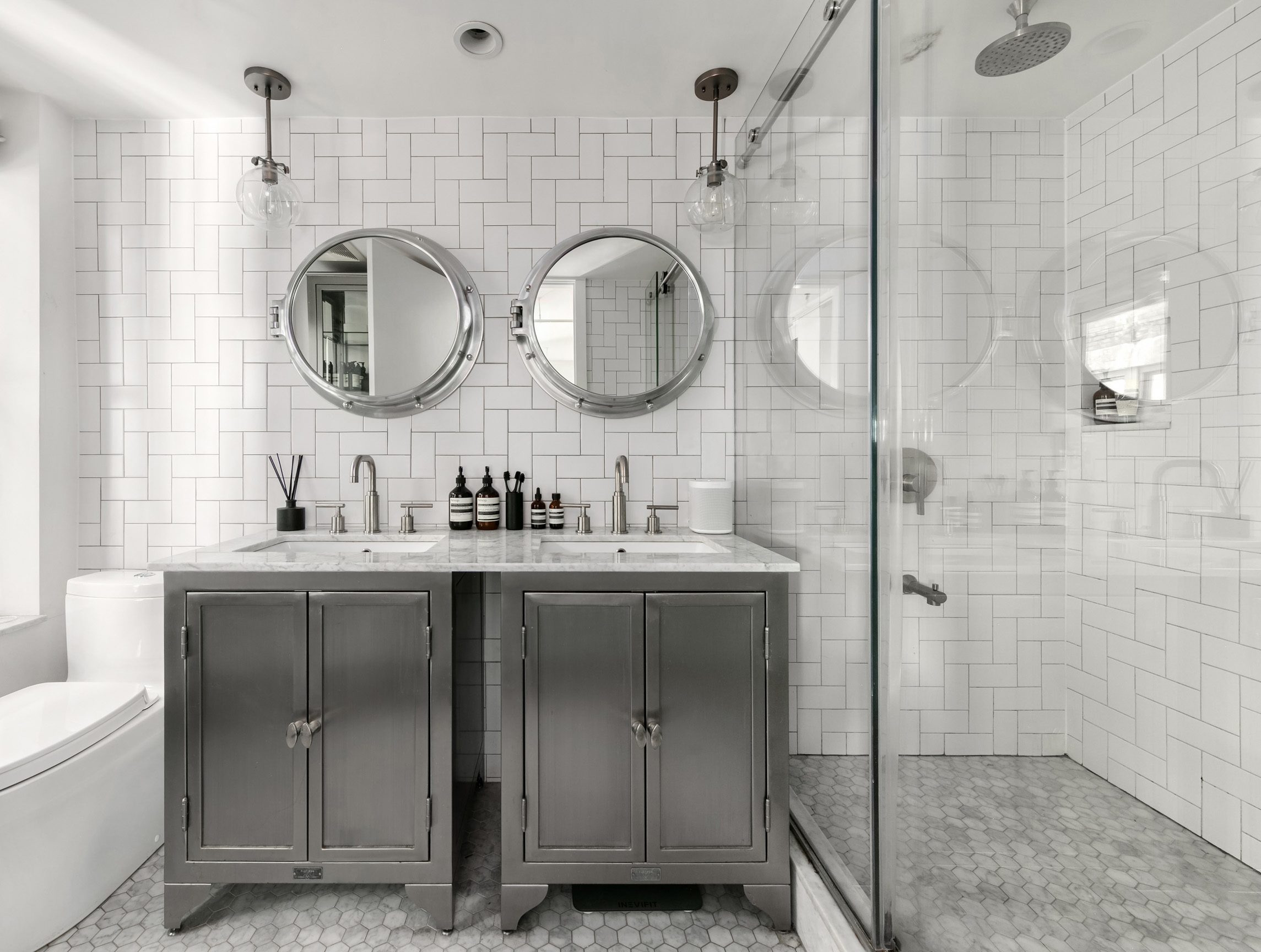 133-131 West 28th Street, Unit 6C Manhattan, NY 10001 - Photo 7 of 10 a bathroom with a mirror a sink and a mirror