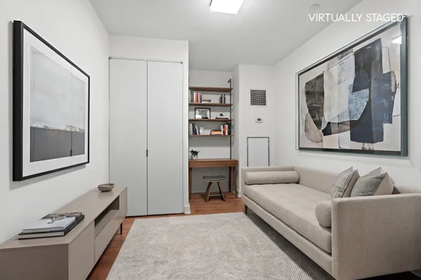 a living room with furniture and painting on the wall