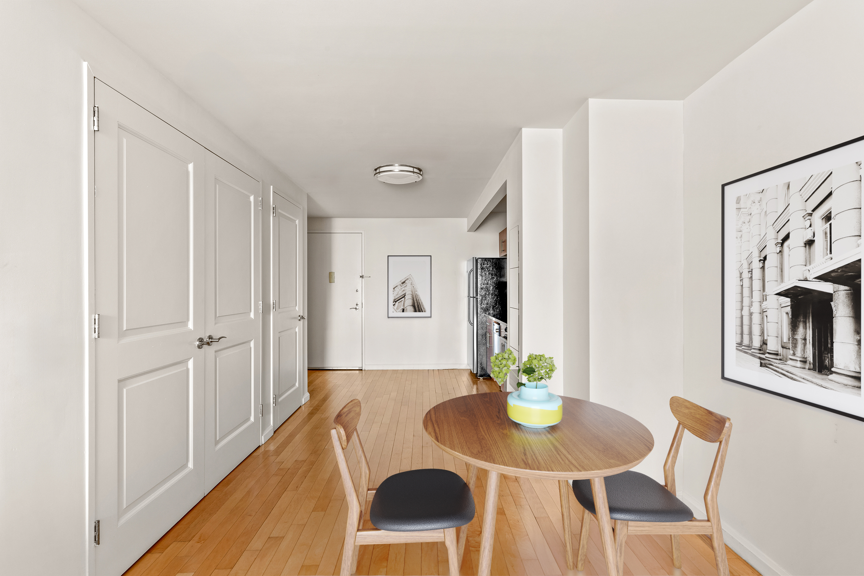 20 West Street, Unit 31C Manhattan, NY 10004 - Photo 4 of 16 a view of a dining room with furniture and a potted plant