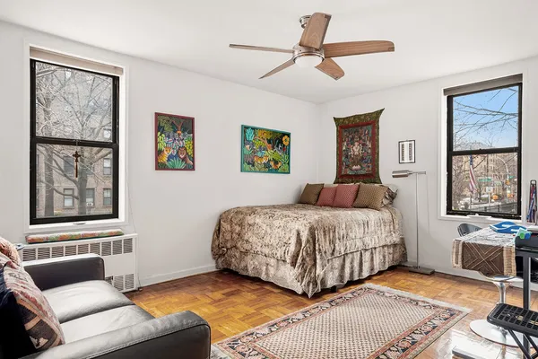 a bedroom with a bed couch and window