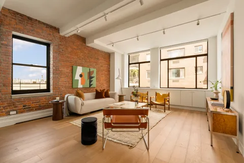 a living room with furniture and large windows
