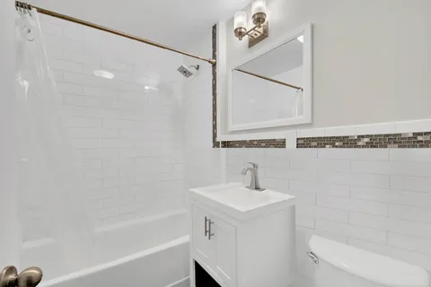 a bathroom with a bathtub a sink and a shower