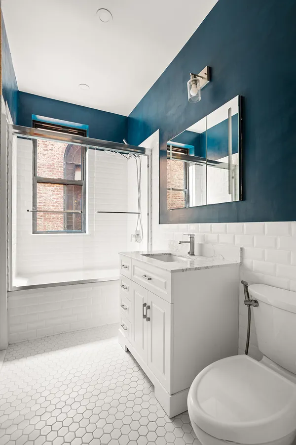 a bathroom with a sink a toilet and bathtub