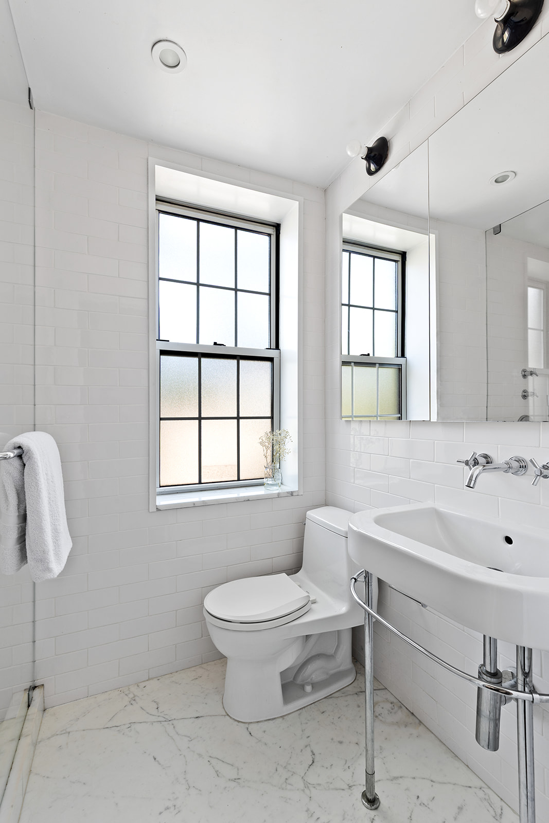 25 Minetta Lane, Unit 5C Manhattan, NY 10012 - Photo 6 of 7 a bathroom with a sink toilet and shower