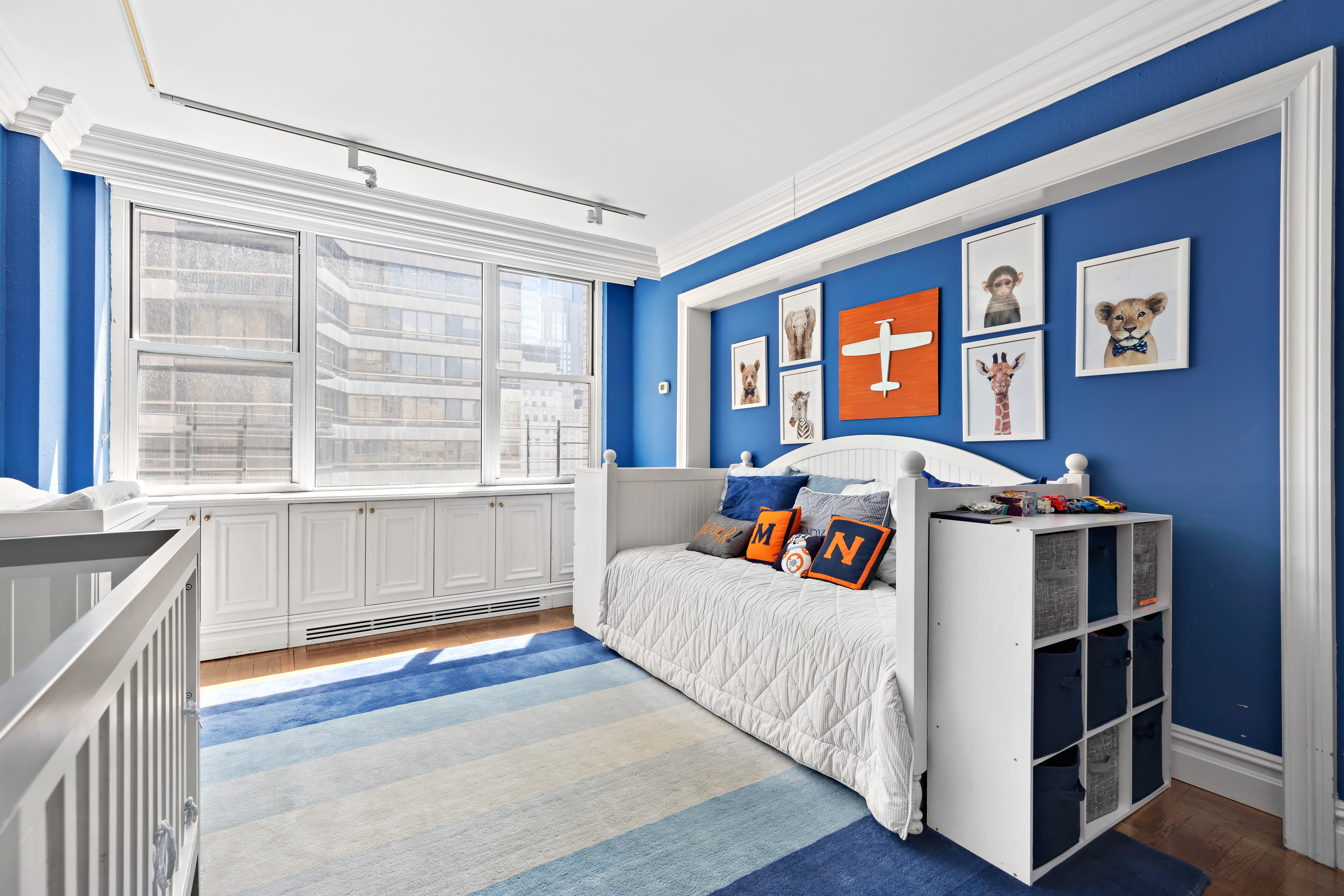 175 East 62nd Street, Unit 9D Manhattan, NY 10065 - Photo 8 of 12 a bedroom with bed and a large window