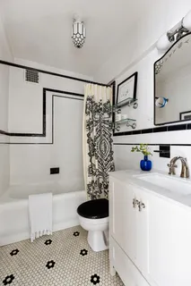 a bathroom with a sink a toilet and a shower