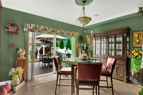 a view of a dining room with furniture a chandelier and wooden floor