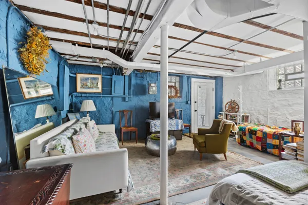 a living room with furniture and a chandelier