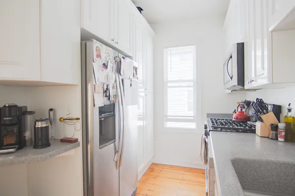 a view of a hallway with cabinet and a window