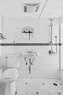 a bathroom with a toilet sink and shower