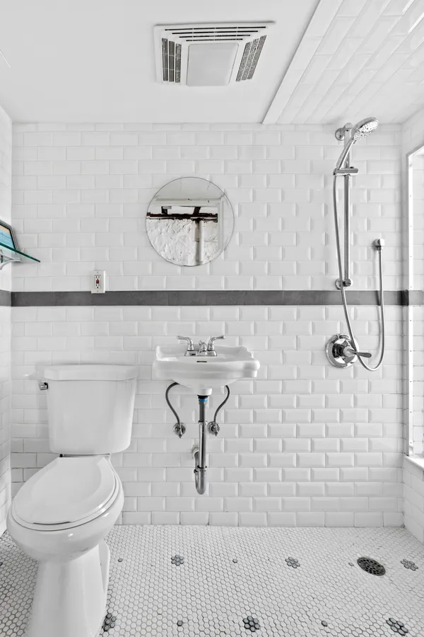 a bathroom with a toilet sink and shower