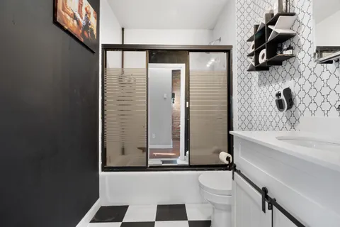 a bathroom with a bathtub and a shower