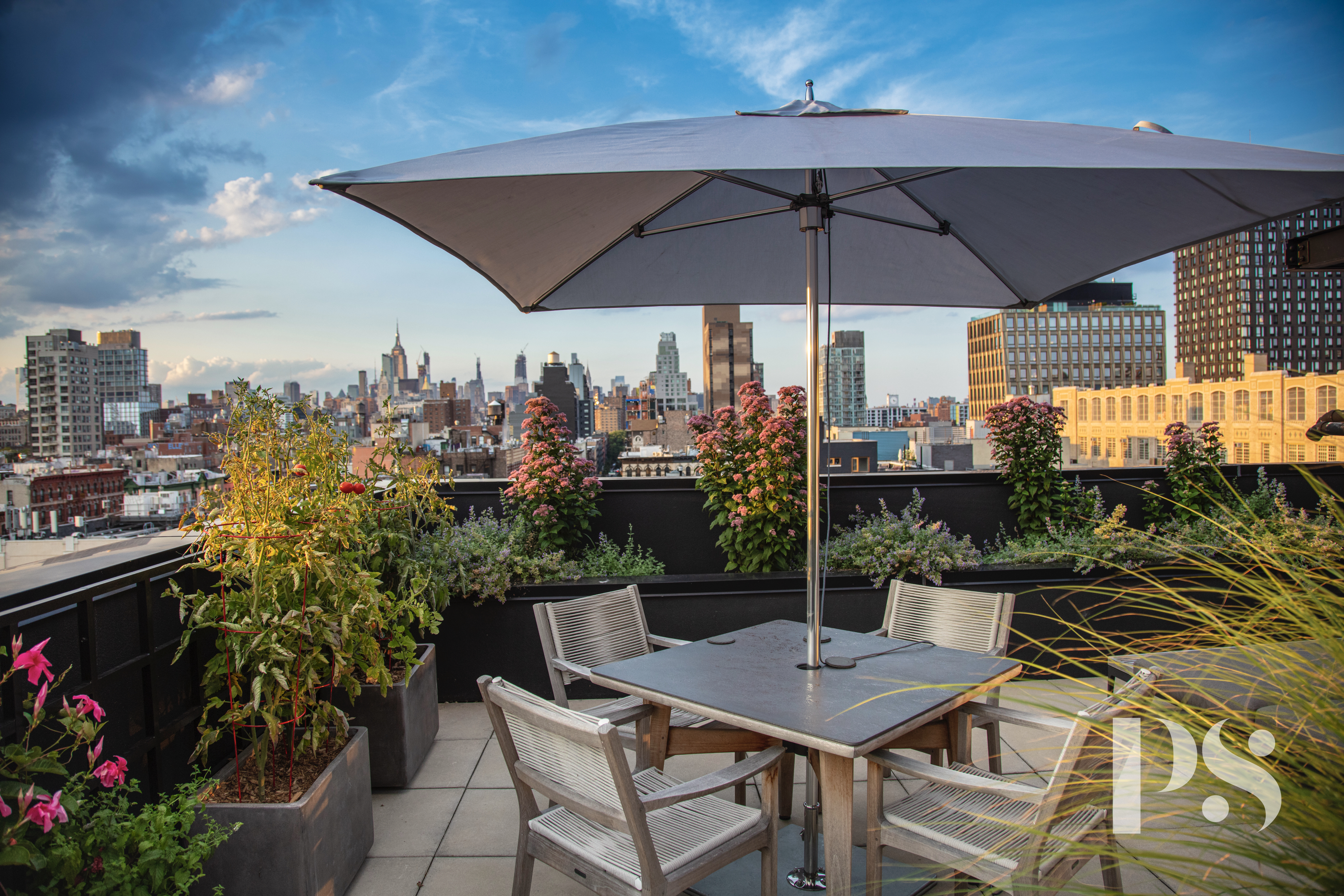 60 Orchard Street, Unit PH Manhattan, NY 10002 - Photo 8 of 19 a view of a patio with table and chairs under an umbrella
