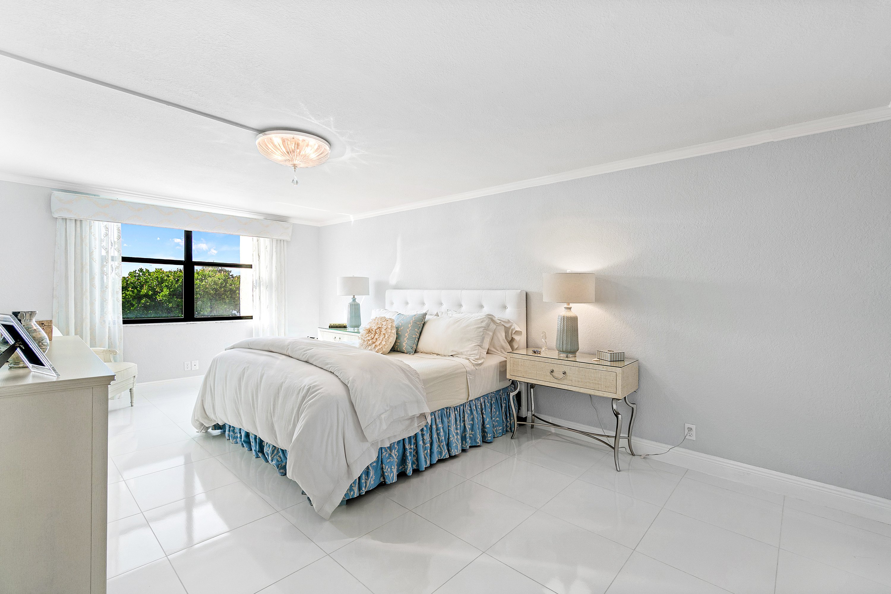 2003 North Ocean Boulevard, Unit 305 Boca Raton, FL 33431 - Photo 41 of 56 a spacious bedroom with a bed and a large window