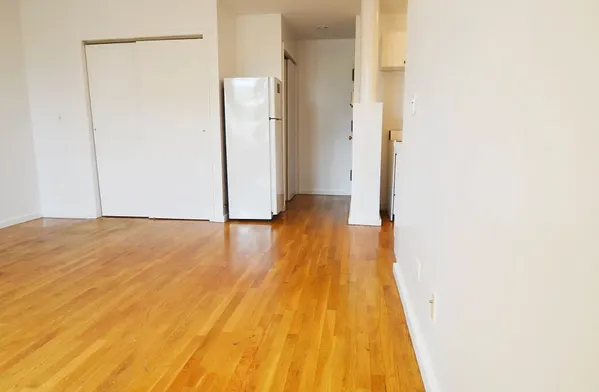 a view of a room with wooden floor