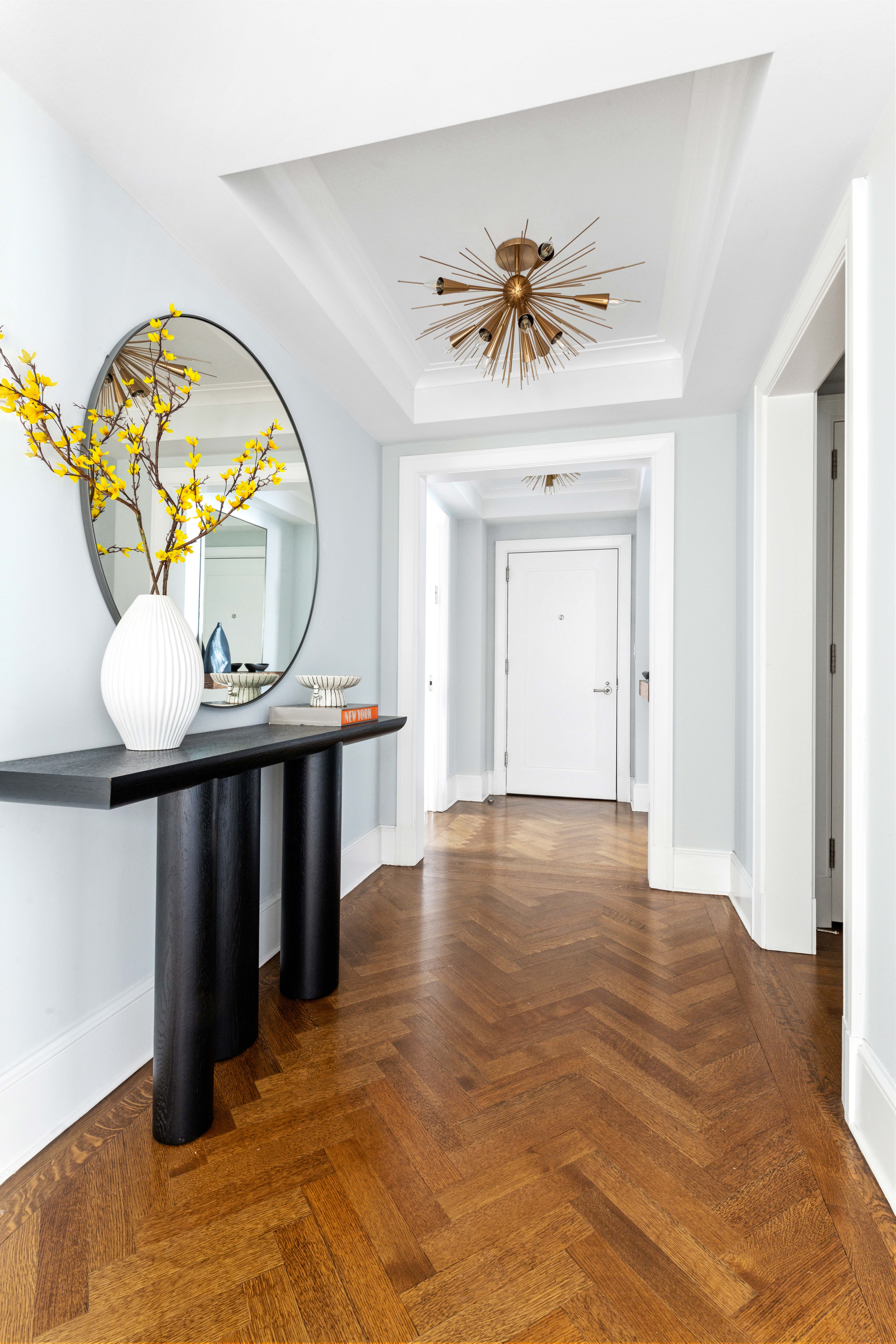 530 Park Avenue, Unit 12F Manhattan, NY 10065 - Photo 5 of 26 wooden floor with a chandelier