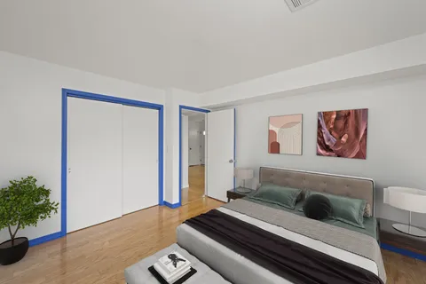 a bedroom with furniture and a potted plant