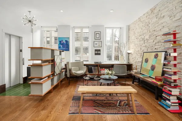 a living room with furniture a rug and a flat screen tv