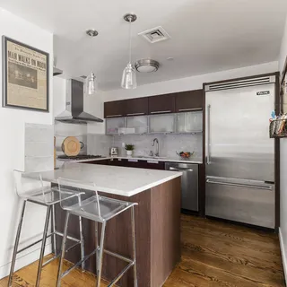 a kitchen with a refrigerator and a sink