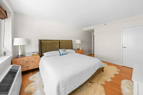 a bedroom with a bed and a lamp