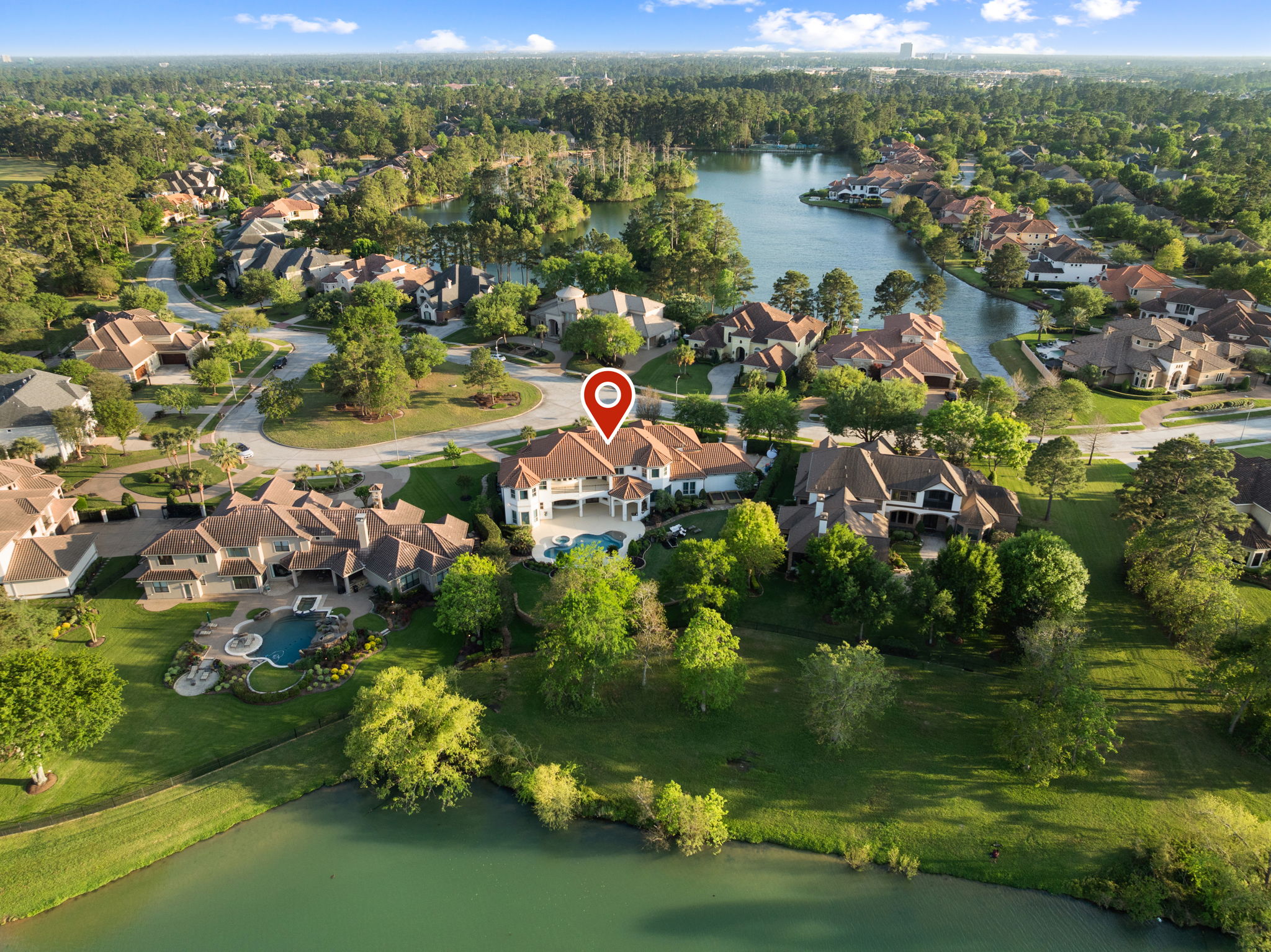82 Manor Lake Estates Circle Spring, TX 77379 - Photo 43 of 52 a view of a lake with a city
