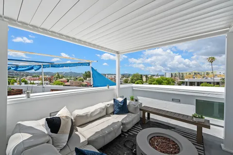 a dining room with furniture and a floor to ceiling window