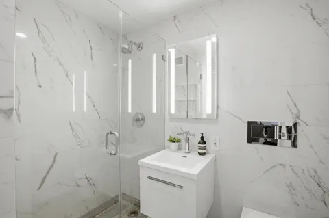 a bathroom with a sink toilet and vanity