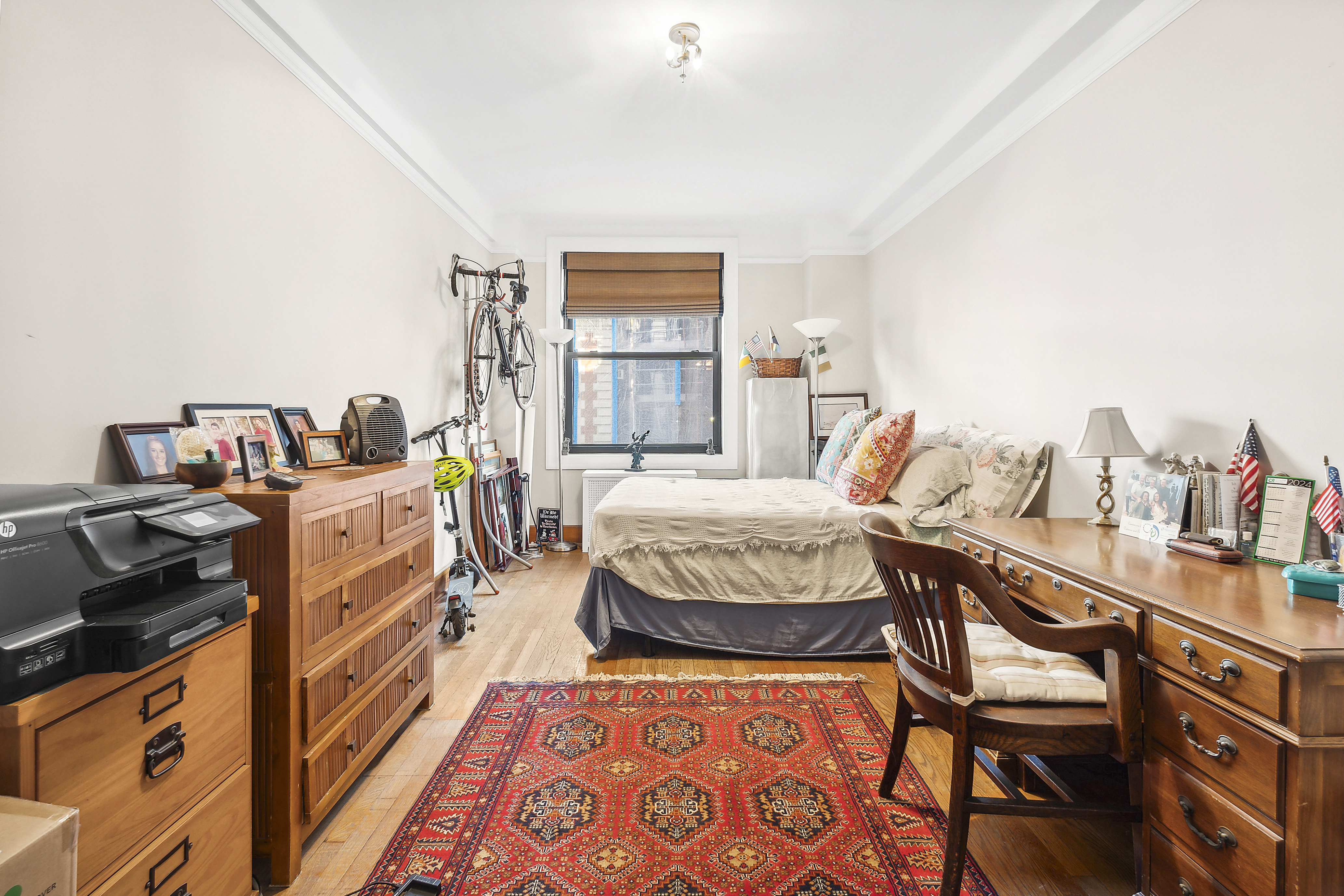 395 Riverside Drive, Unit 5F Manhattan, NY 10025 - Photo 5 of 8 a bedroom with a bed and a table in it
